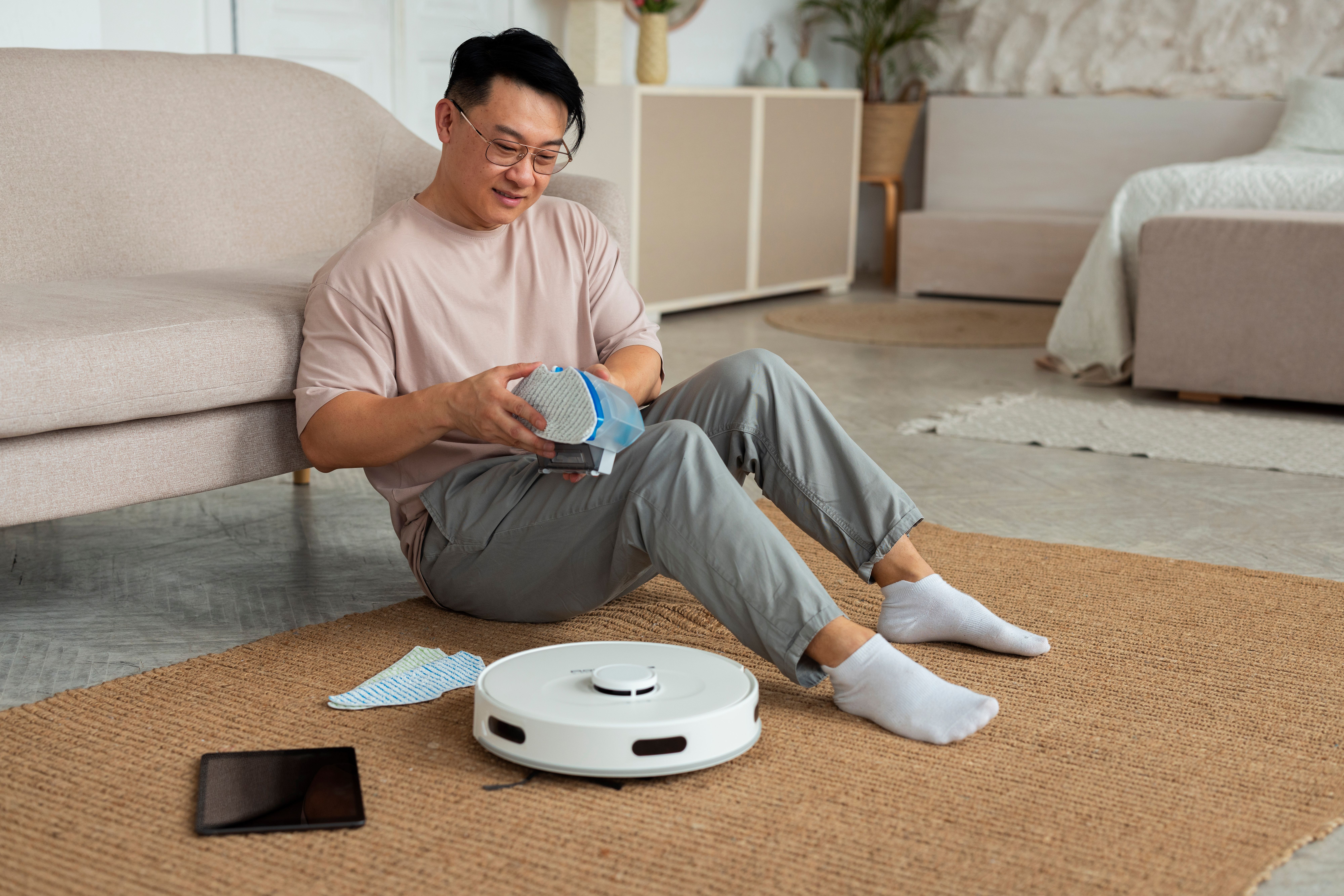 full-shot-man-with-robotic-vacuum-cleaner-home.jpg